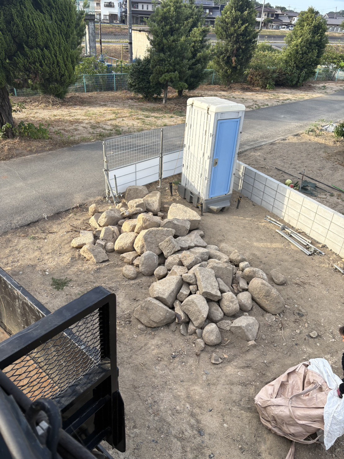 倉敷市粒江の新築予定地に、大きな石やコンクリート片が一か所に集められている施工前の状態